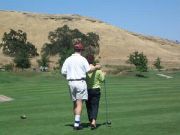 Michael walking with Helen to hit the first ball