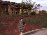 Bagpiper calls in the golfers